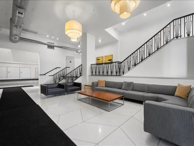 a living room with furniture and stairs