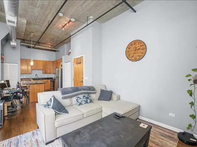 a living room with furniture and kitchen view