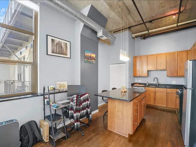 a large kitchen with stainless steel appliances granite countertop a stove and a sink