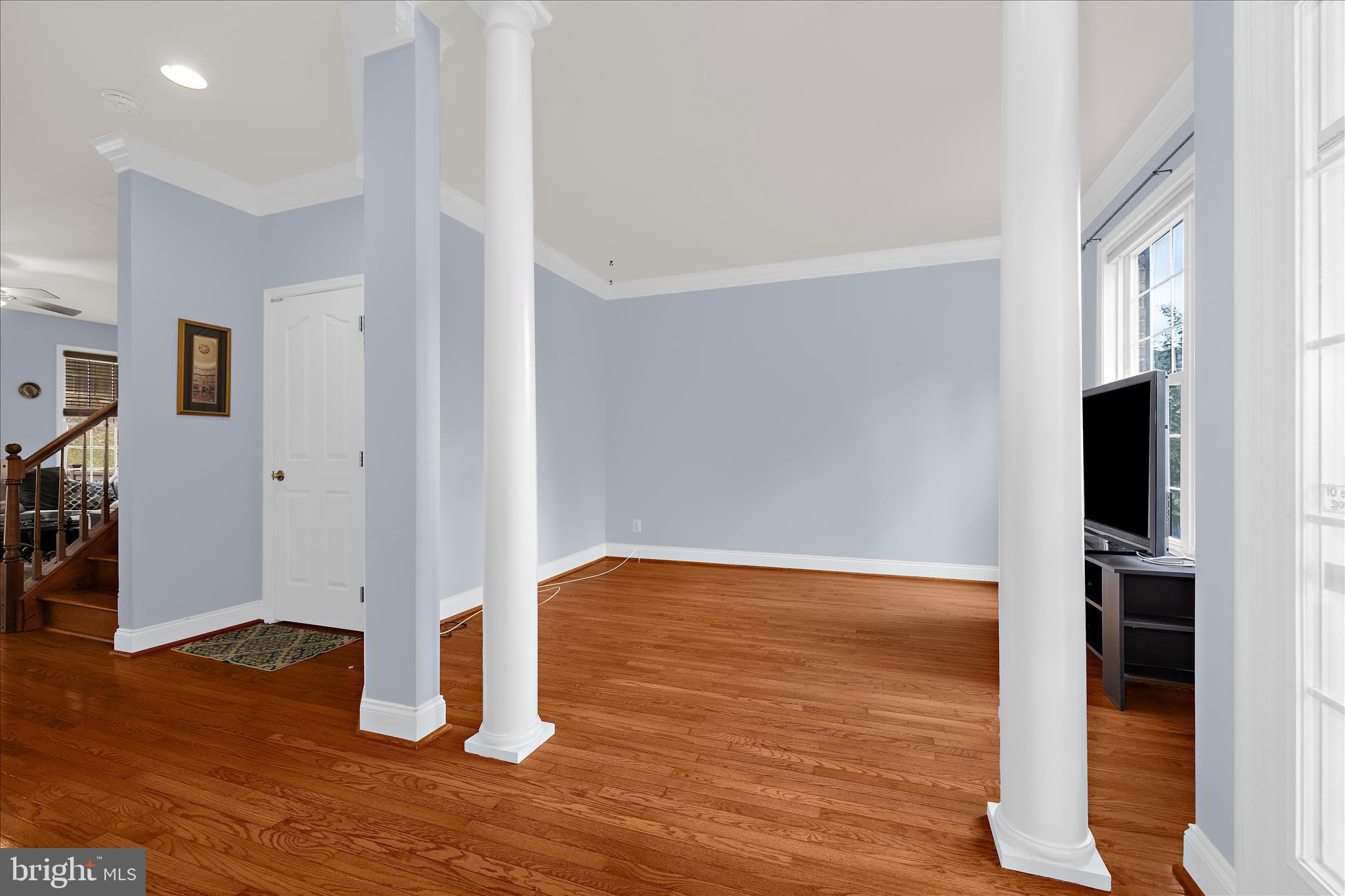 211 Still Water Lane Huntingtown, MD 20639 - Photo 12 of 87 a view of empty room with wooden floor and fan