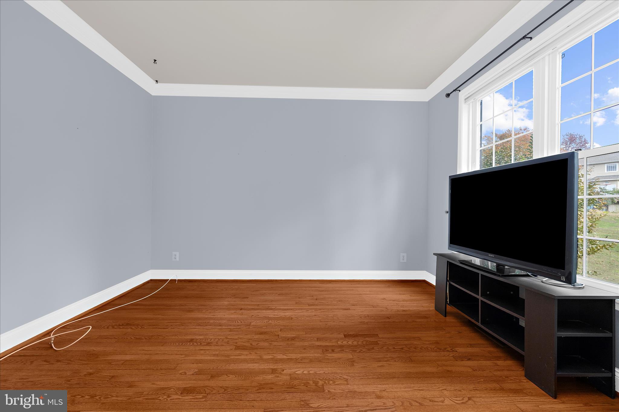 211 Still Water Lane Huntingtown, MD 20639 - Photo 15 of 87 a view of a room with wooden floor and flat screen tv
