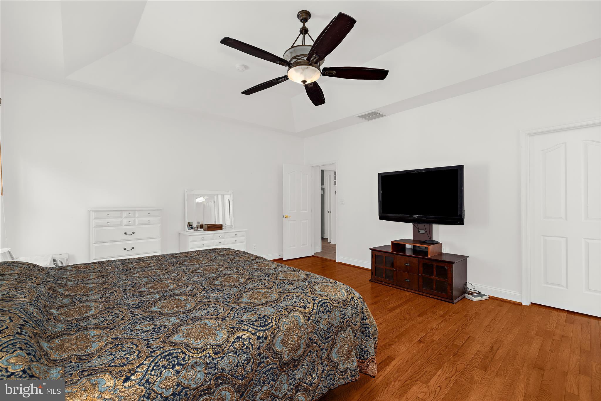 211 Still Water Lane Huntingtown, MD 20639 - Photo 34 of 87 a bedroom with a bed and a flat screen tv