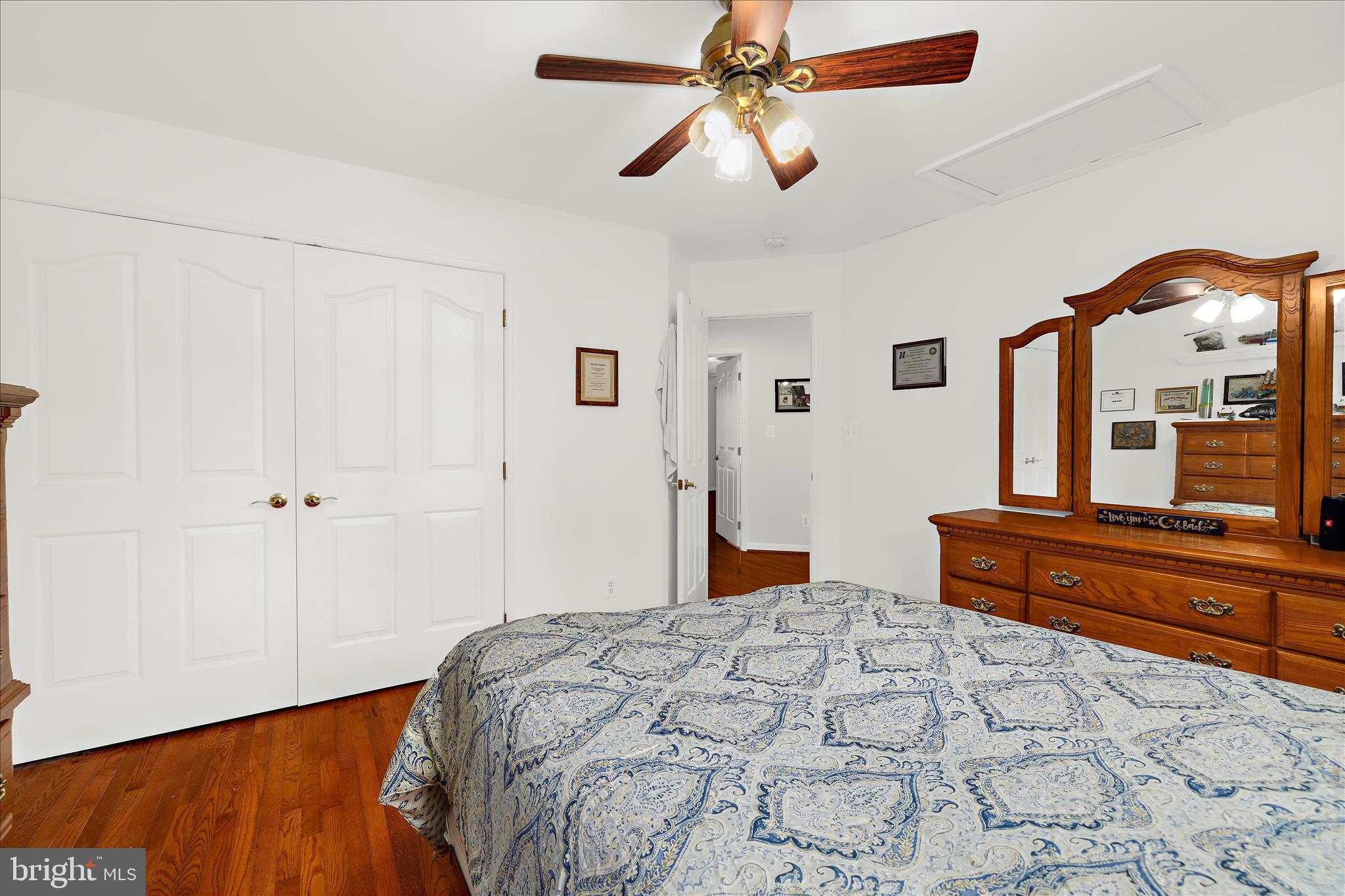 211 Still Water Lane Huntingtown, MD 20639 - Photo 50 of 87 a bedroom with a bed and a chandelier