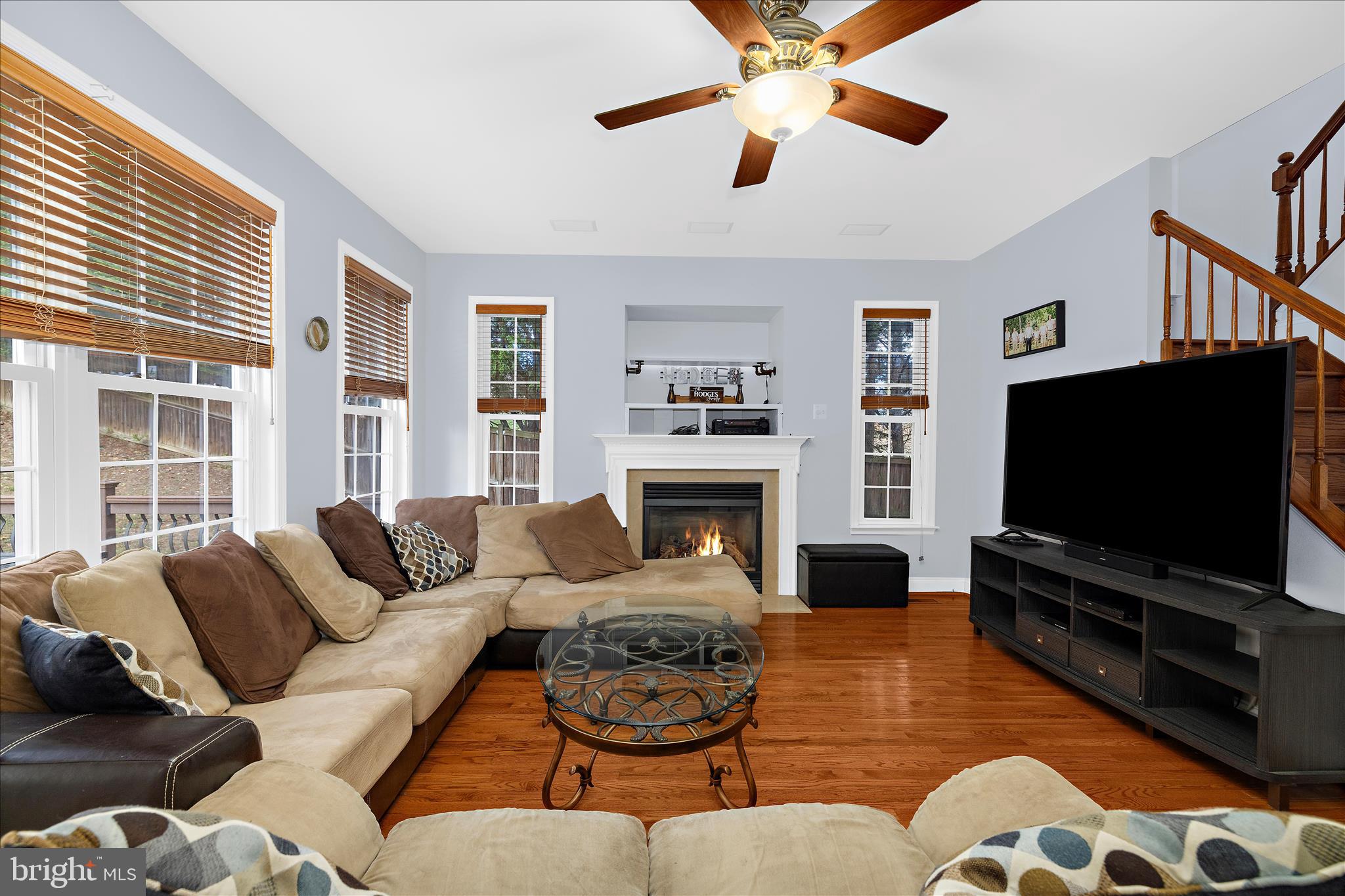 211 Still Water Lane Huntingtown, MD 20639 - Photo 5 of 87 a living room with fireplace furniture and a flat screen tv