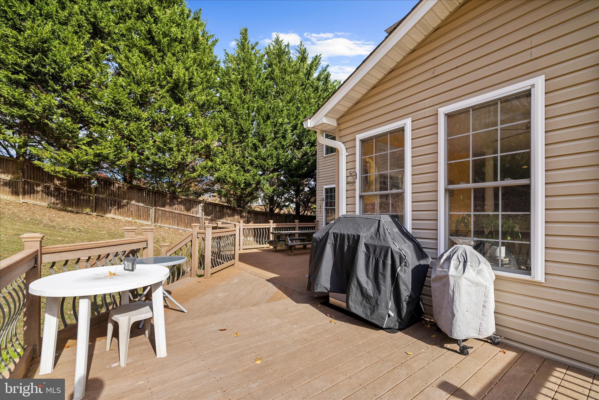 211 Still Water Lane Huntingtown, MD 20639 - Photo 63 of 87 a view of a patio with table and chairs with wooden floor and fence
