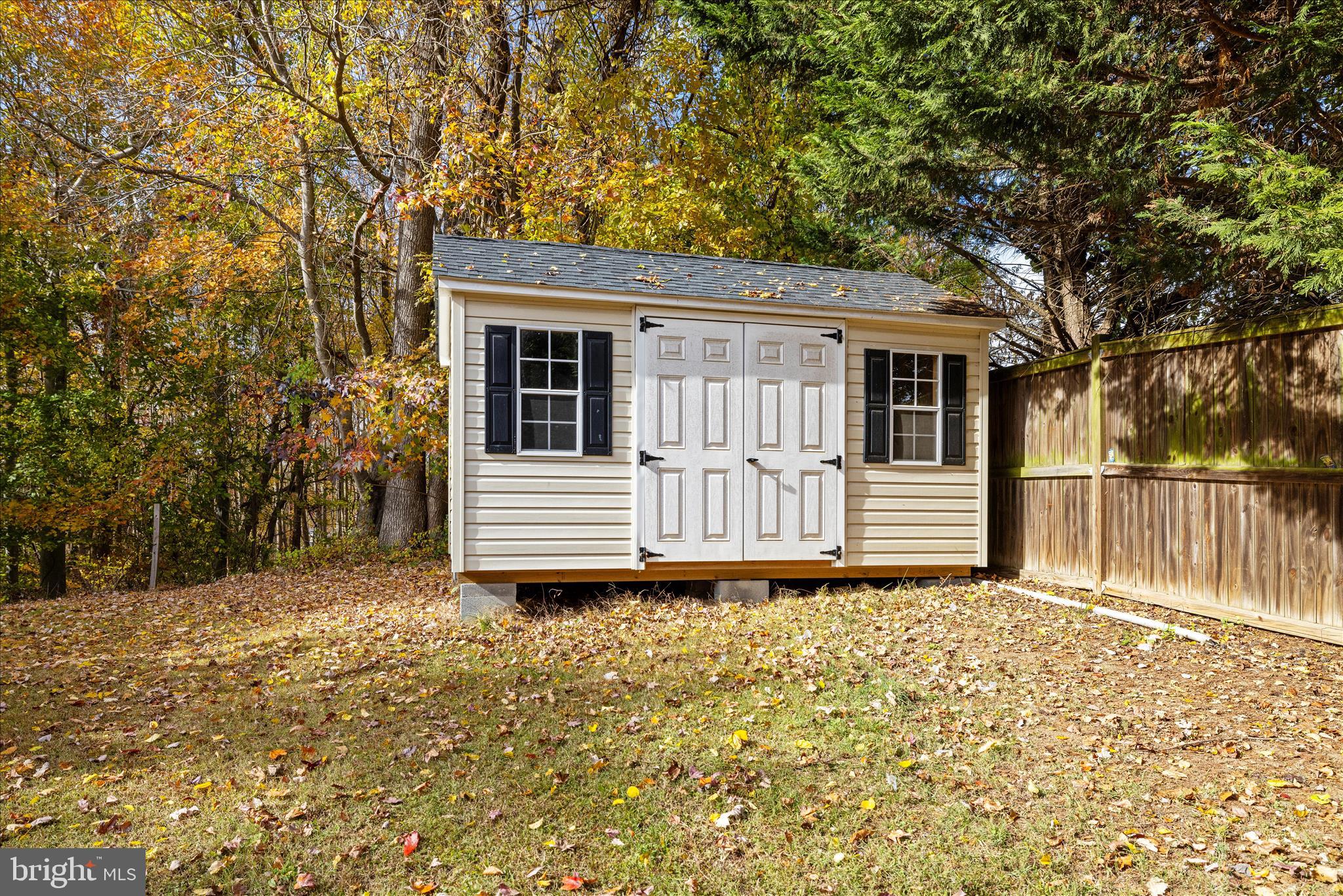 211 Still Water Lane Huntingtown, MD 20639 - Photo 69 of 87 a view of a house with a small yard and large trees