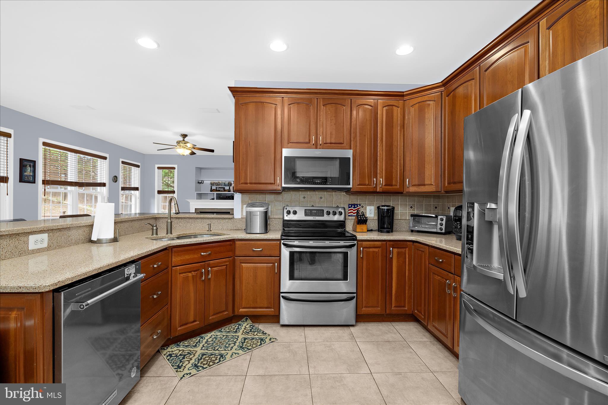 211 Still Water Lane Huntingtown, MD 20639 - Photo 7 of 87 a kitchen with stainless steel appliances granite countertop a stove top oven a sink and dishwasher