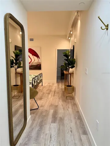 a view of a hallway with wooden floor