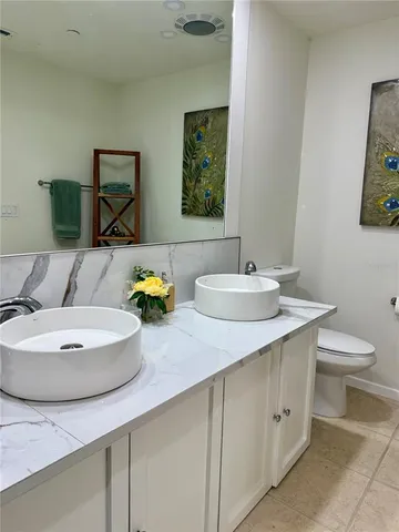 a bathroom with a double vanity sink and a mirror