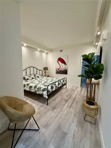 a bedroom with furniture and a potted plant