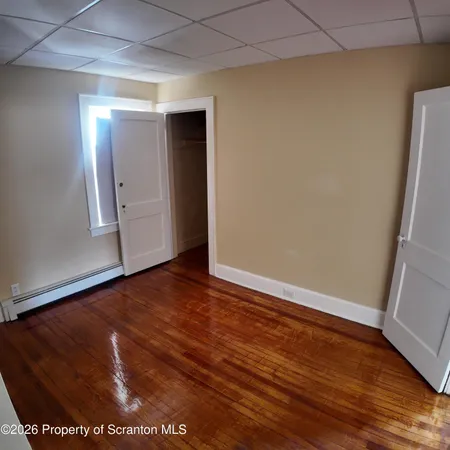 an empty room with wooden floor