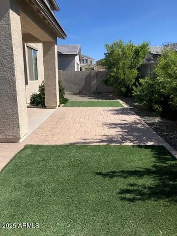 a view of a white house with a yard