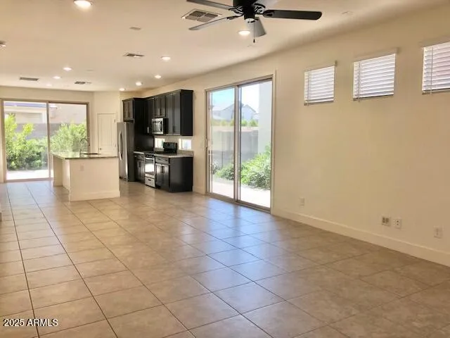 a kitchen with kitchen island granite countertop stainless steel appliances a refrigerator stove microwave and sink