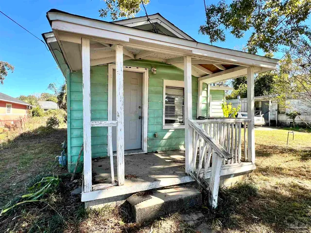 a view of a patio with a table and chairs