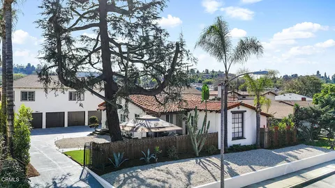 a front view of a house with garden view