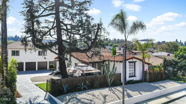 a front view of a house with garden view