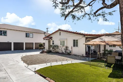 a view of a white house with a patio