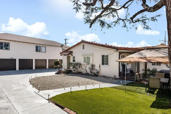 a view of a white house with a patio