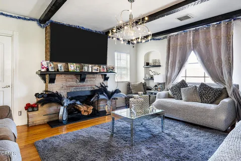 a kitchen with stainless steel appliances granite countertop a sink a stove a refrigerator and cabinets