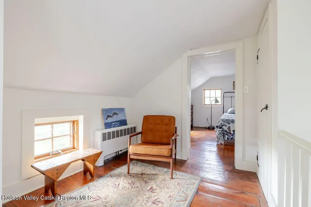 a bedroom with a bed table and a window