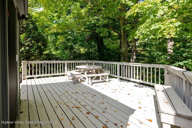a view of balcony with wooden floor and outdoor seating