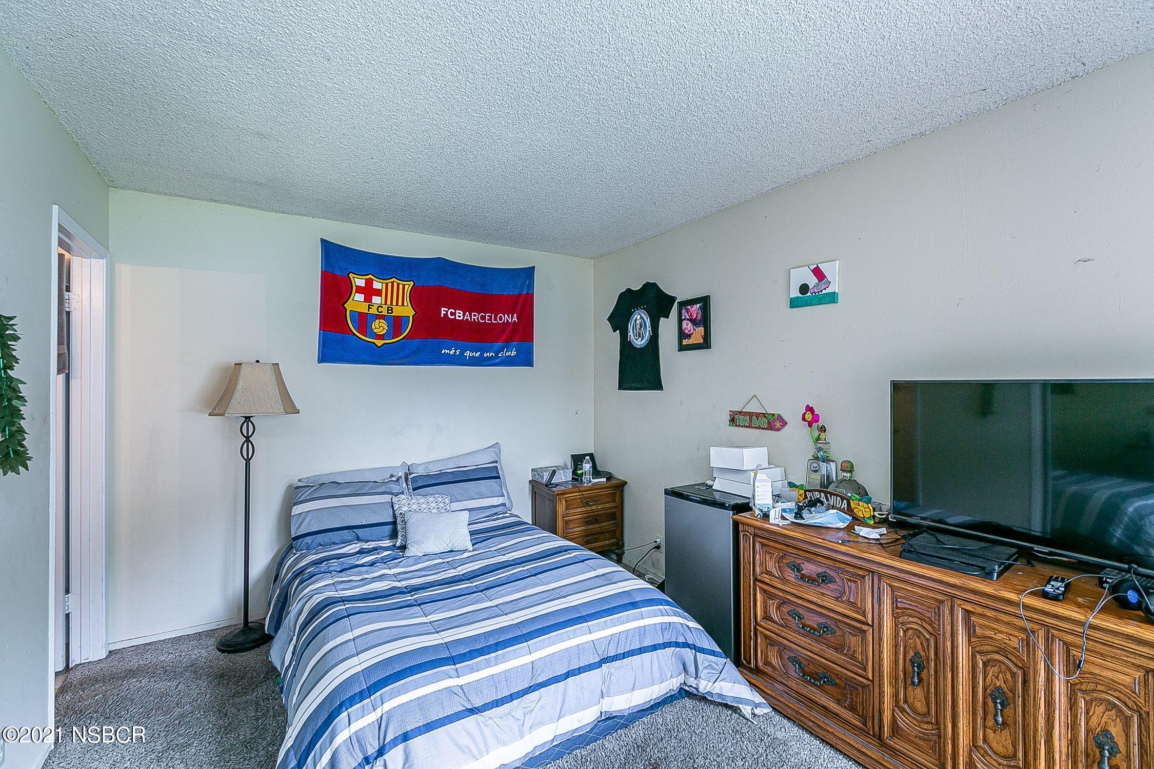 902 North O Street Lompoc, CA 93436 - Photo 11 of 25 a bedroom with bed and a flat screen tv