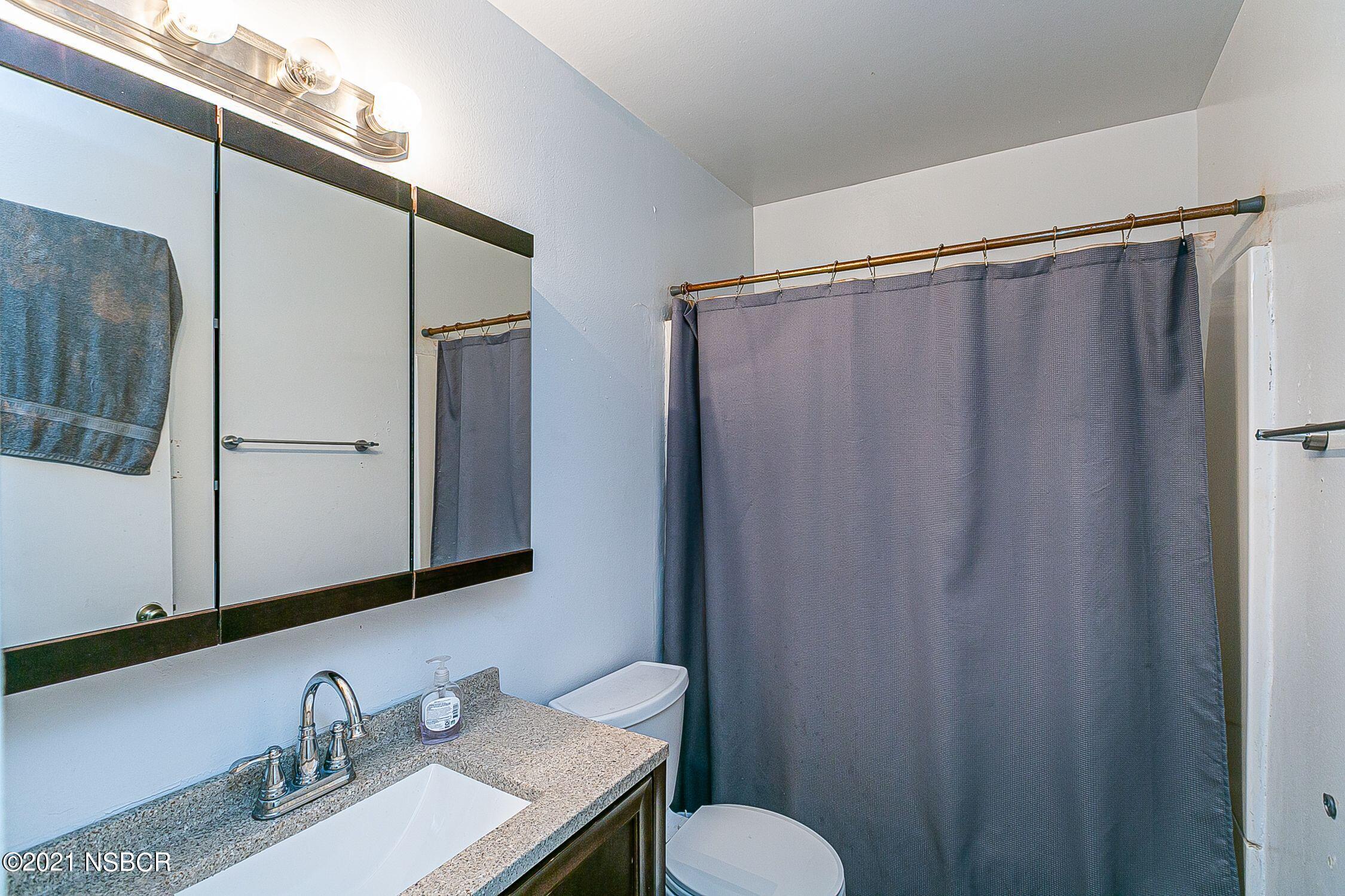 902 North O Street Lompoc, CA 93436 - Photo 15 of 25 a bathroom with a sink and a mirror