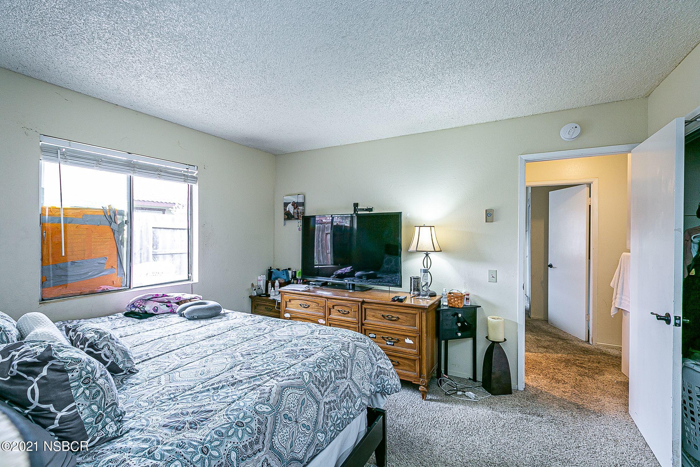 902 North O Street Lompoc, CA 93436 - Photo 17 of 25 a bedroom with a bed and a flat screen tv