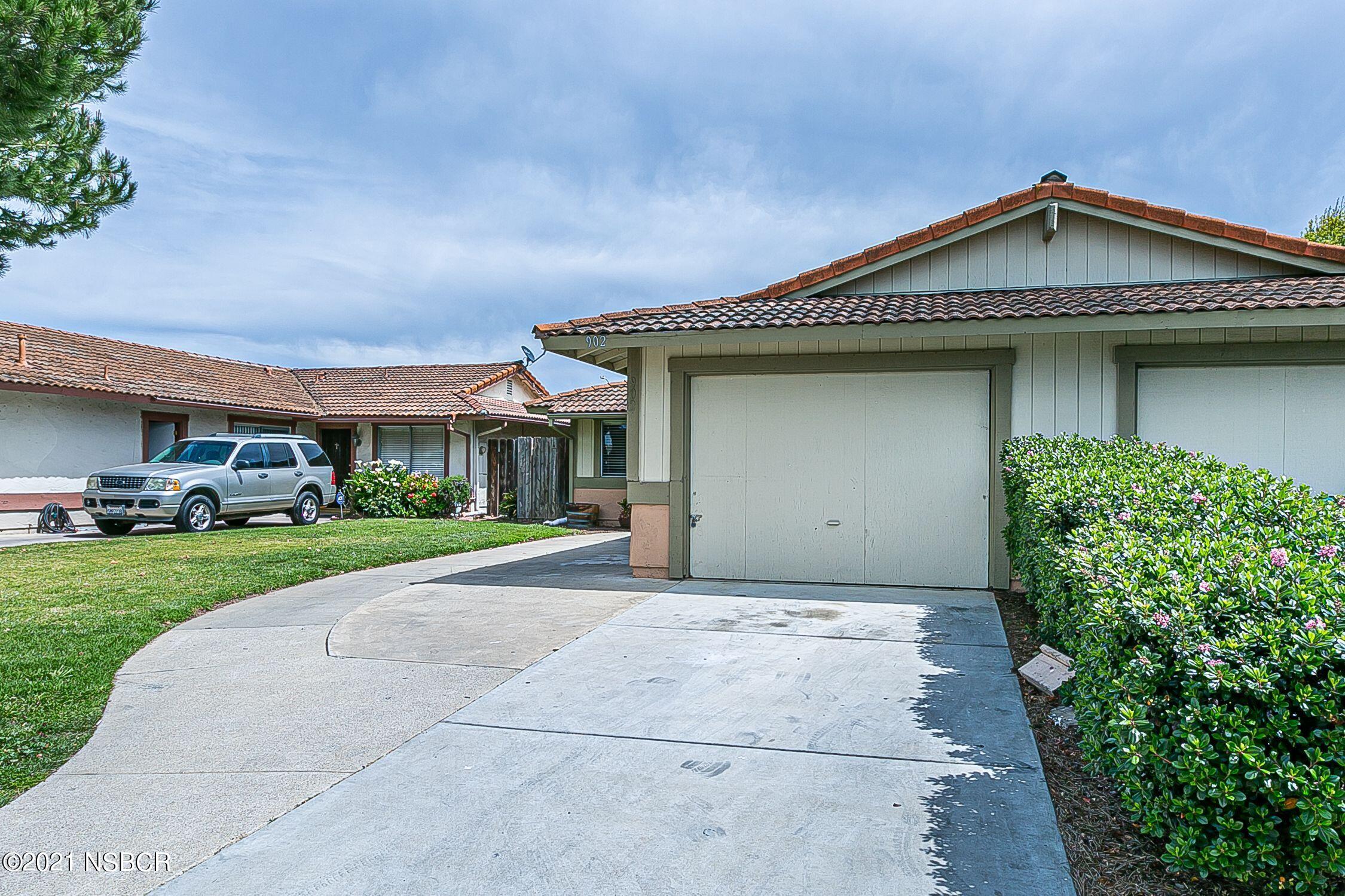 902 North O Street Lompoc, CA 93436 - Photo 3 of 25 a front view of a house with a yard and garage