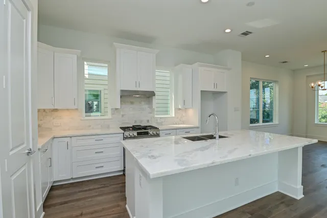 a kitchen with a stove a sink and a refrigerator