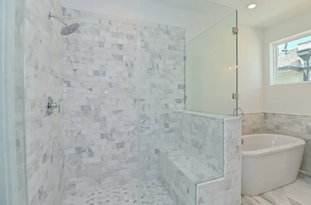 a bathroom with a bathtub and shower