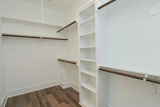 a view of walk in closet with empty racks