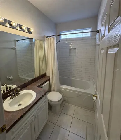 a bathroom with a sink toilet a mirror and shower