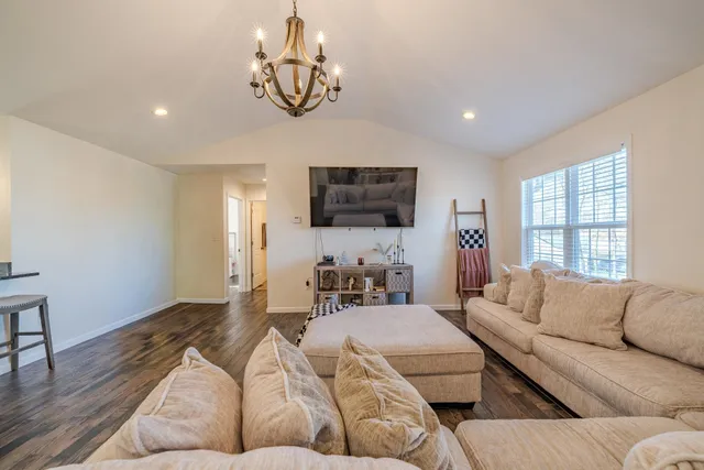 a living room with furniture and a wooden floor