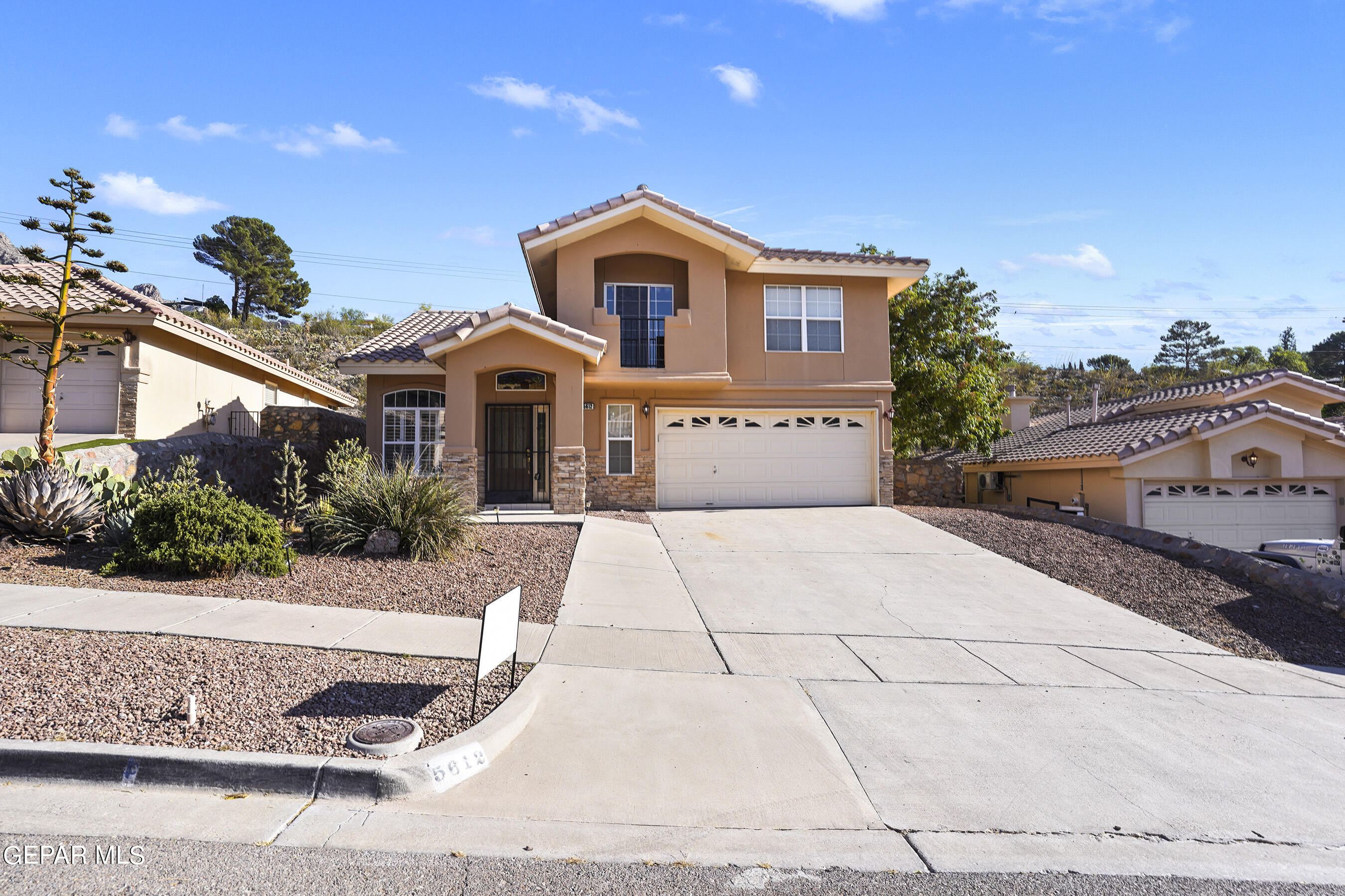 5612 Burning Tree Drive El Paso, TX 79912 - Photo 1 of 35 a front view of a house with a yard and garage
