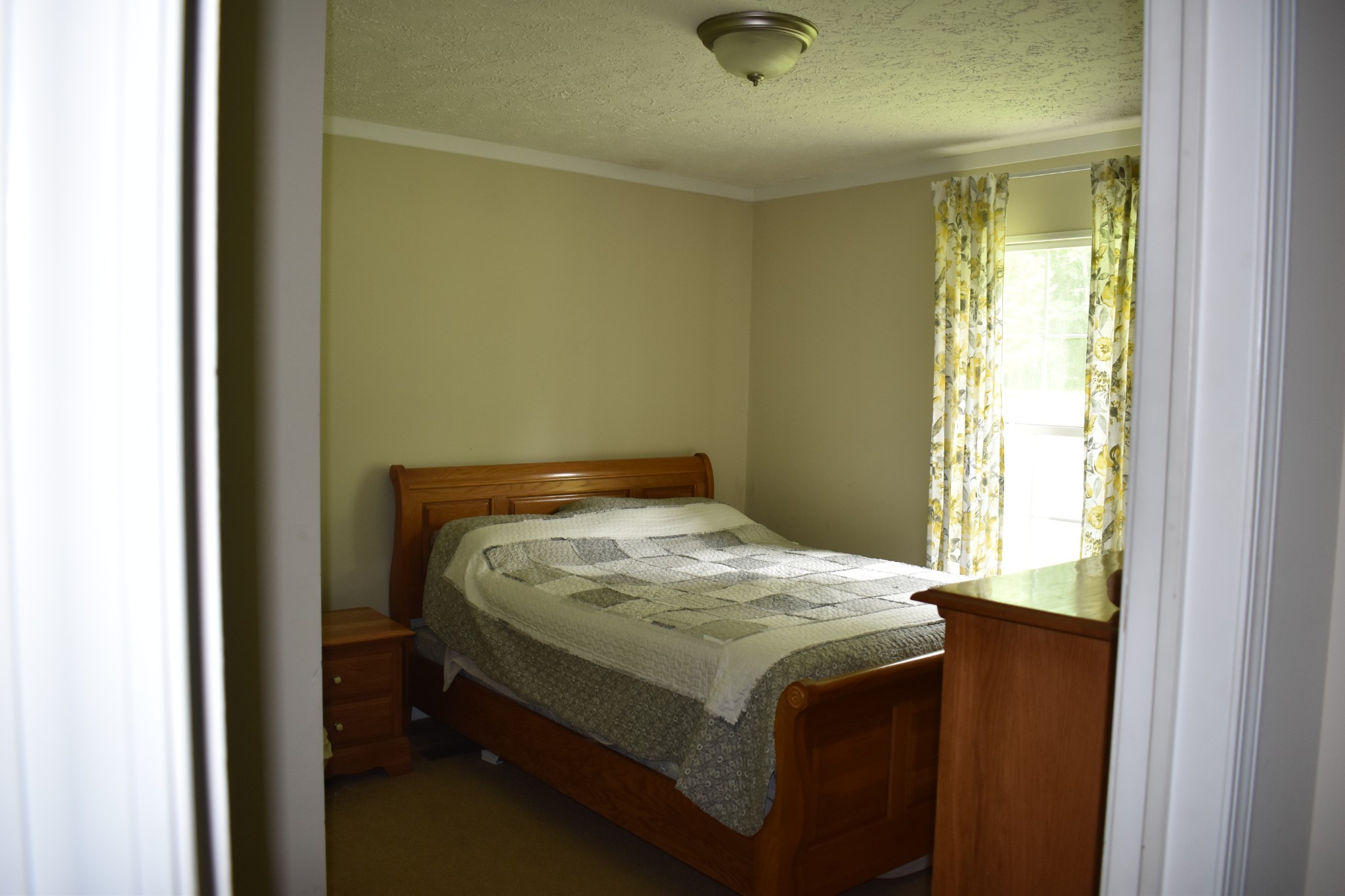 1423 Pack Road White Bluff, TN 37187 - Photo 24 of 50 a bed sitting in a bedroom next to a window