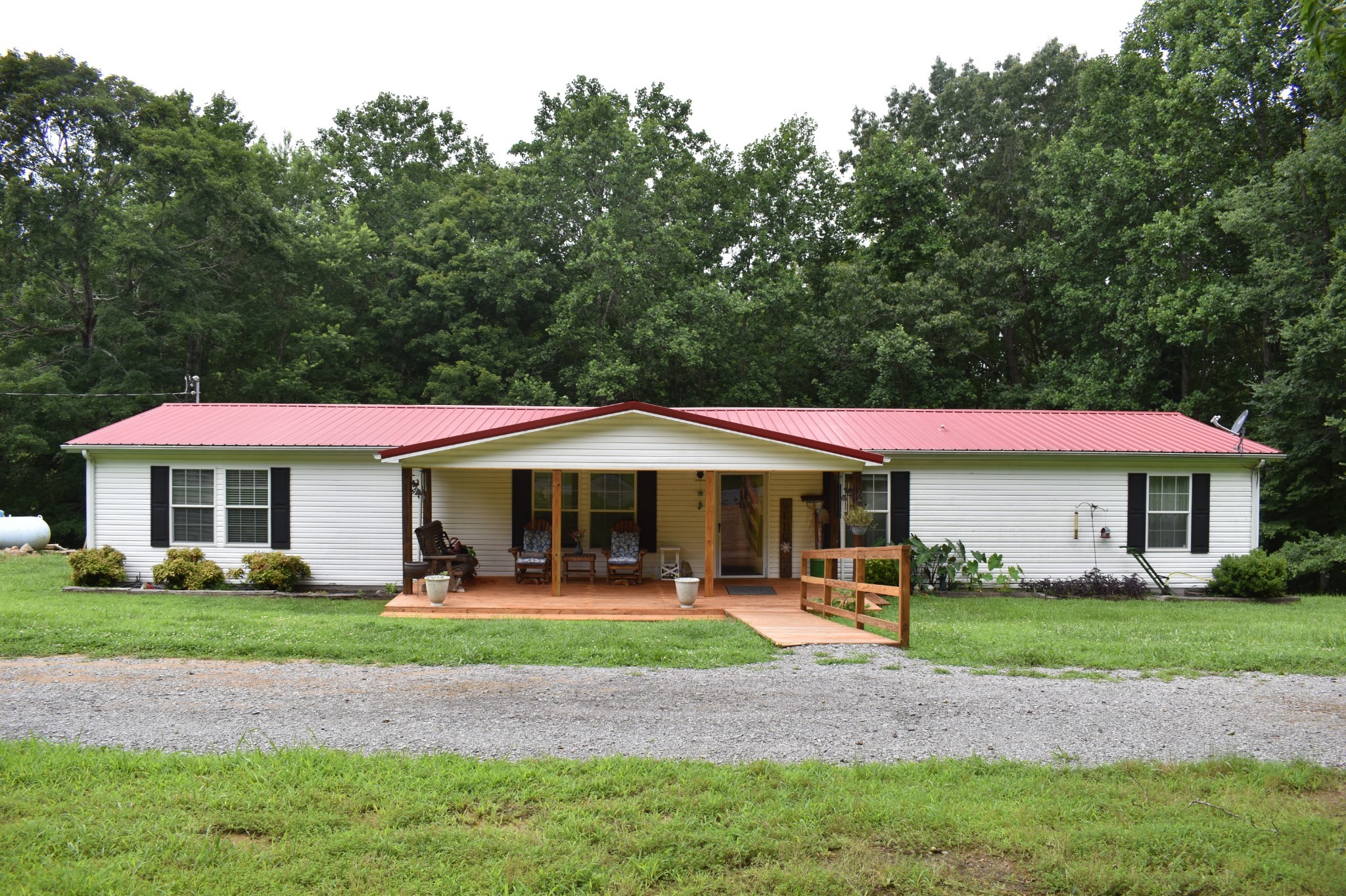 1423 Pack Road White Bluff, TN 37187 - Photo 3 of 50 a patio with a table and chairs under an umbrella