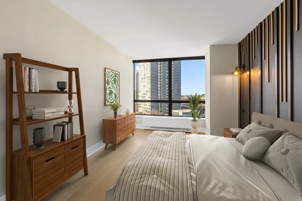 a bedroom with furniture and a large window