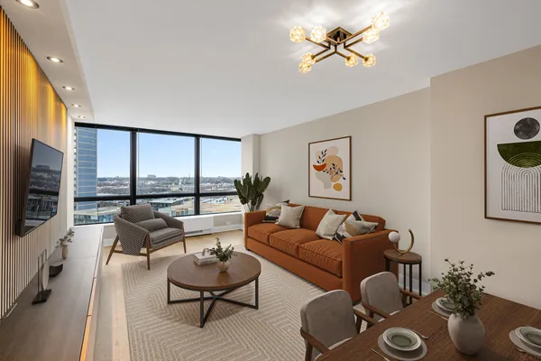 a living room with furniture a flat screen tv and a large window