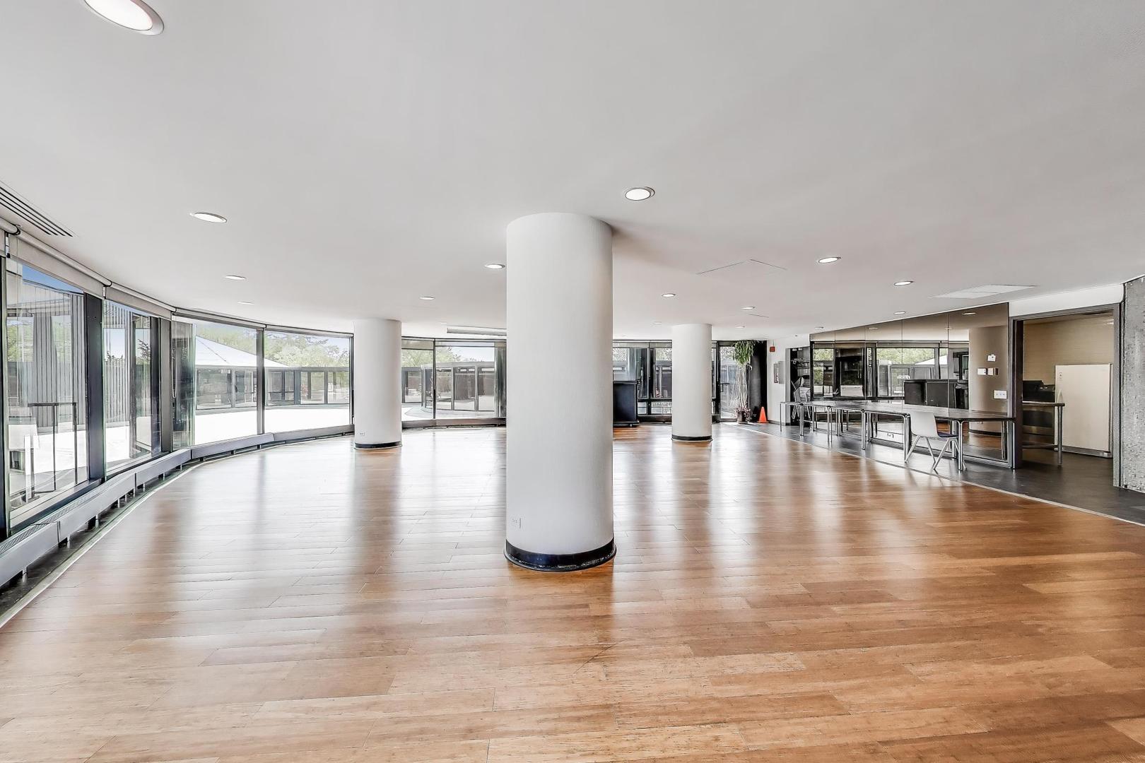 5415 North Sheridan Road, Unit 915 Chicago, IL 60640 - Photo 26 of 28 a view of an entryway with wooden floor and windows