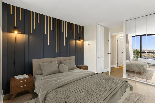 a bedroom with a bed and a mirror