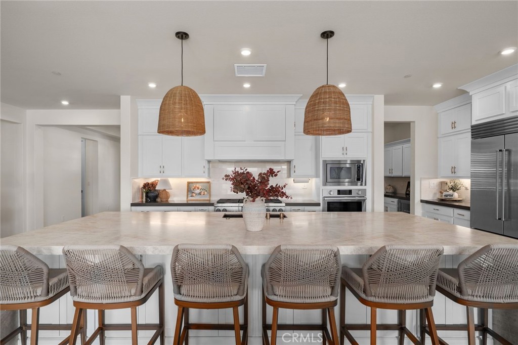 16155 New Canaan Court Riverside, CA 92504 - Photo 13 of 26 a kitchen with kitchen island granite countertop a table and chairs in it