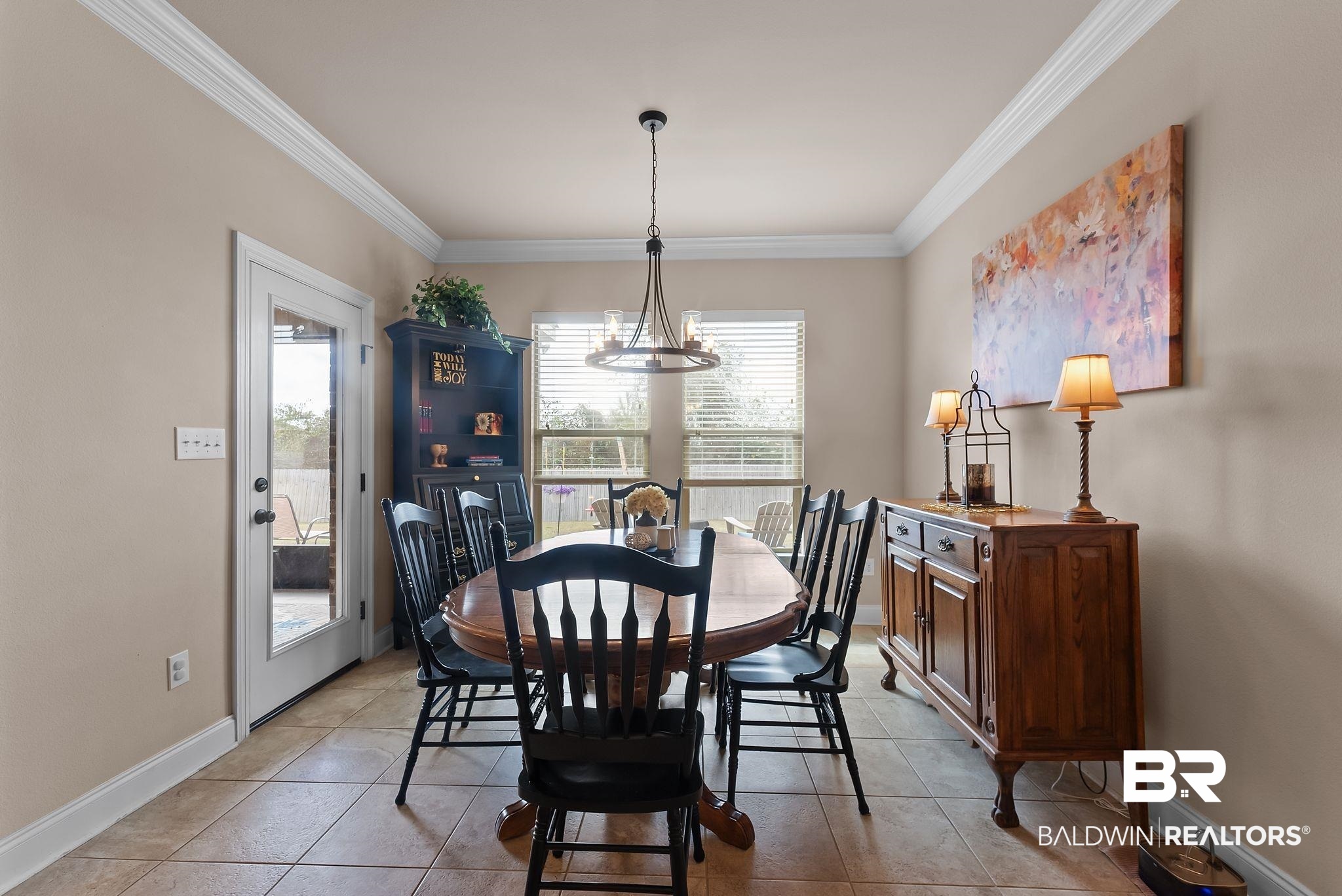 7015 Rocky Rd Loop Gulf Shores, AL 36542 - Photo 18 of 41 Dining space featuring ornamental molding and light tile patterned flooring
