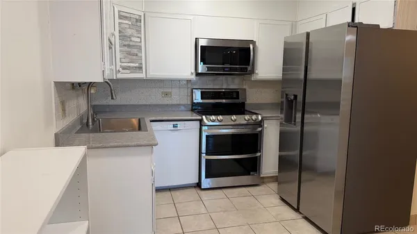 a kitchen with a stove microwave and refrigerator