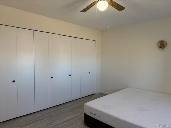 a room that has a bed and a chandelier fan