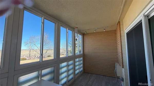 a view of a hallway with windows and stairs