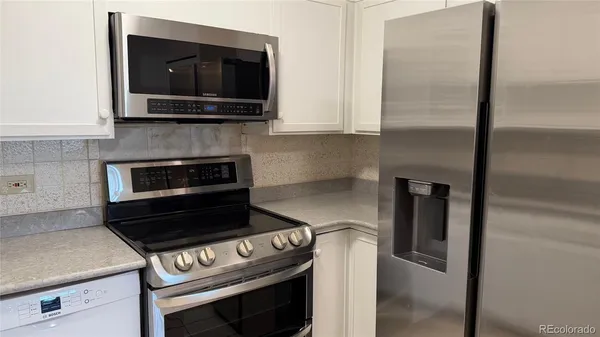 a kitchen with a stove and a microwave
