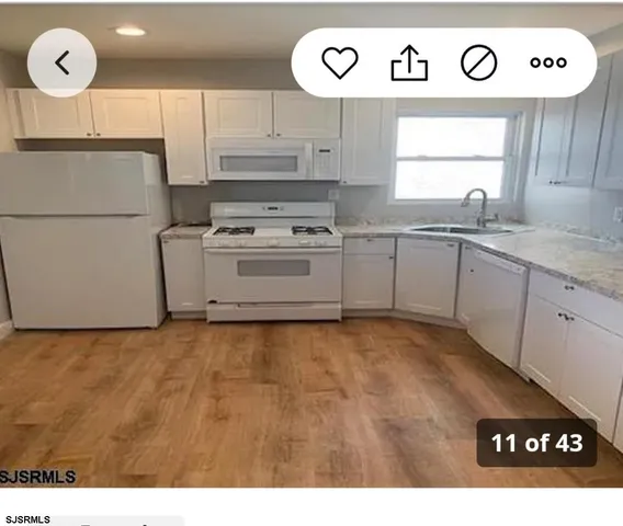 a kitchen with a refrigerator and a sink