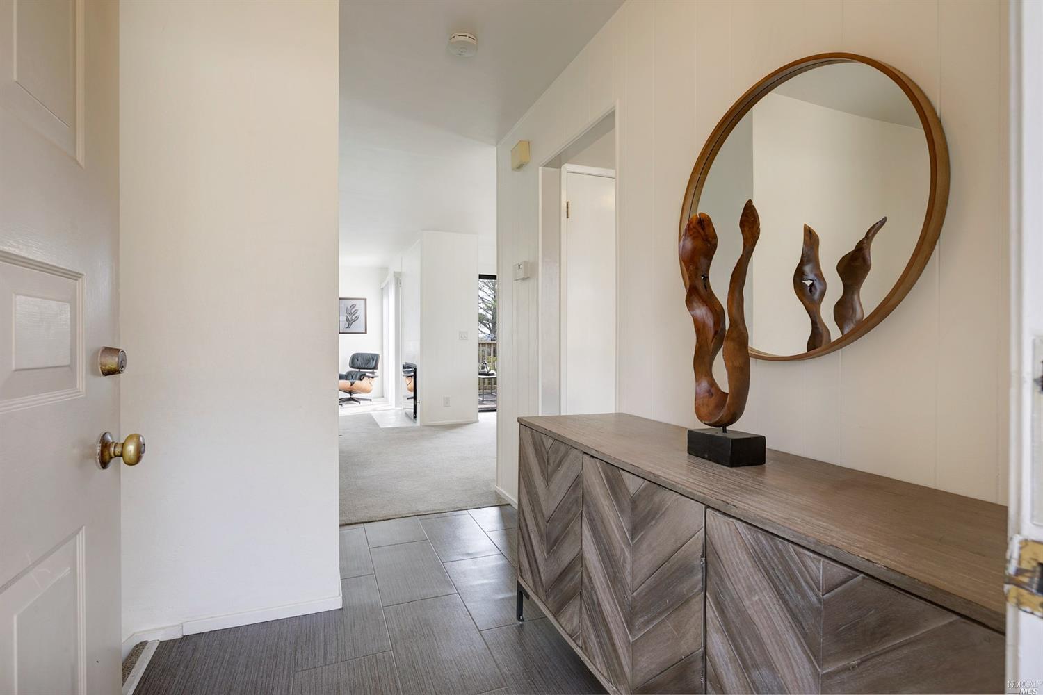 a view of a livingroom with wooden floor and entryway