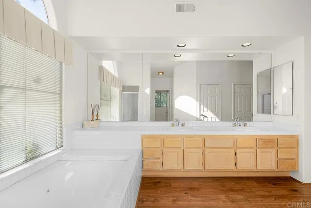 a view of a livingroom with wooden floor and staircase